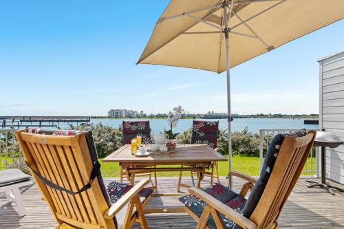 a patio with a table and chairs and an umbrella at Pamir in Kappeln