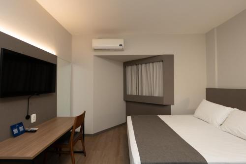 Ένα ή περισσότερα κρεβάτια σε δωμάτιο στο Hotel Caiuá