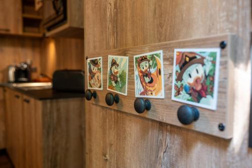 a wooden door with magnets and pictures on it at Disney Davy Crockett Ranch in Villeneuve-le-Comte