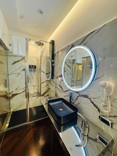 a bathroom with a sink and a mirror at B&B Amo' in Forlì