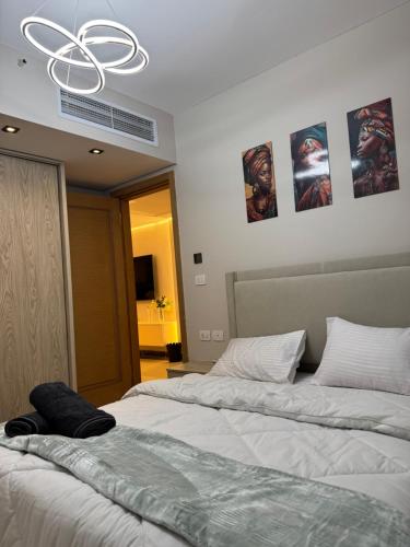 two beds in a bedroom with posters on the wall at elegant hotel studio Porto New Cairo pool access in Cairo