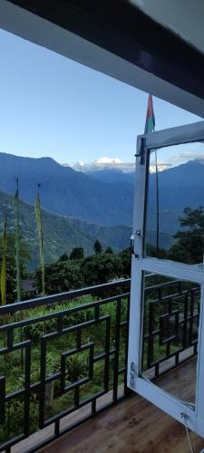 an open door to a balcony with a view at Mochilero Nomads in Pelling