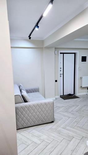 a white room with a bed in the middle at Testimiteanu Airy Dream in Chişinău