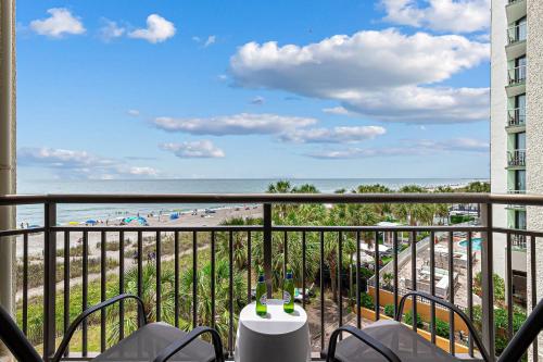 a balcony with a view of a beach and the ocean at Casa Palmera By Casanita - Small-Dog Friendly Suite in Myrtle Beach