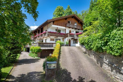 a house in the middle of a driveway at Panorama Apartments Walter in Ortisei