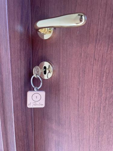 a lock on a wooden door with a key at Wake&Relax in Decollatura
