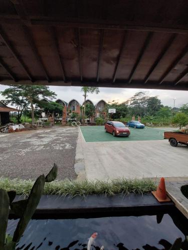 a view of a parking lot with a red car at Villa Saung Wira in Cirebon