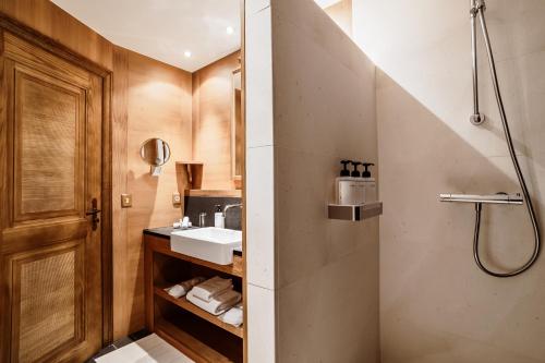 a bathroom with a sink and a shower at Hotel Annapurna in Courchevel