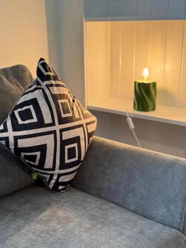 a pillow sitting on a couch in a living room at Highland Nook in Fort William