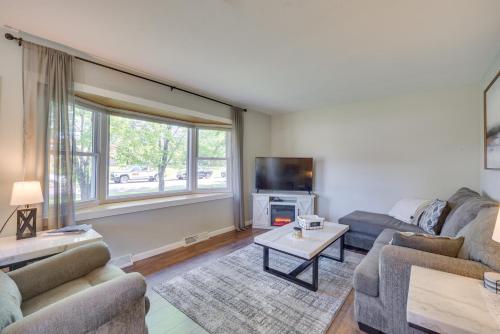 a living room with two couches and a tv at Sunny Cloquet Home - 2 Mi to St Louis River! in Cloquet