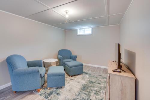 a waiting room with two chairs and a flat screen tv at Sunny Cloquet Home - 2 Mi to St Louis River! in Cloquet