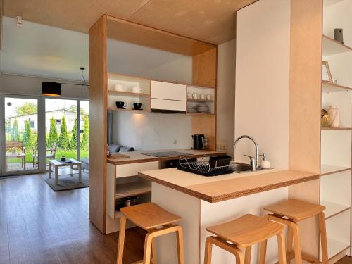 a kitchen with wooden stools and a counter top at Stay in Sigulda #16 in Sigulda