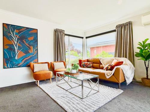 a living room with a couch and a table at 6 Guests Family Home 7 Minutes to Airport in Christchurch