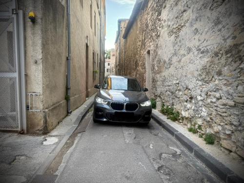 a car parked on a street in an alley at Duplex-Ceiling height 1,9m-Free private parking-Self check in !! Duplex climatisé-Hauteur sous plafond 1,9m-Parking privé gratuit-Arrivée autonome !! in Avignon