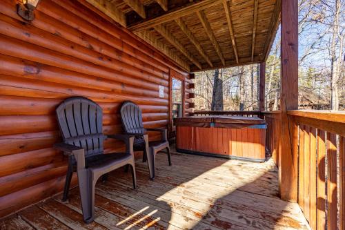 two chairs sitting on the porch of a cabin at Sunny Side Up by American Patriot Getaways in Oldham