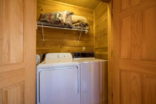 a washer and dryer in a room with wooden walls at Sunny Side Up by American Patriot Getaways in Oldham