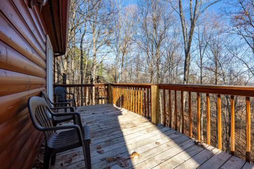 a porch of a cabin with two chairs on it at Sunny Side Up by American Patriot Getaways in Oldham