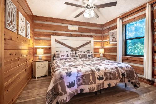 a bedroom with a bed and a ceiling fan at Dogwood's Smoky Mtn Cabin Hot Tub And Views in Sevierville