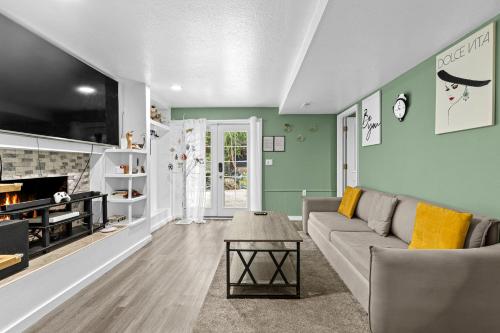 a living room with a couch and a fireplace at Garden Suite Two Bedroom with Hot Tub Sauna Outdoor kitchen and Game Room in Everett