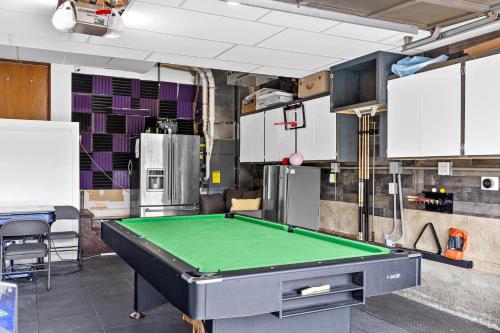 a garage with a pool table in a room at Garden Suite Two Bedroom with Hot Tub Sauna Outdoor kitchen and Game Room in Everett