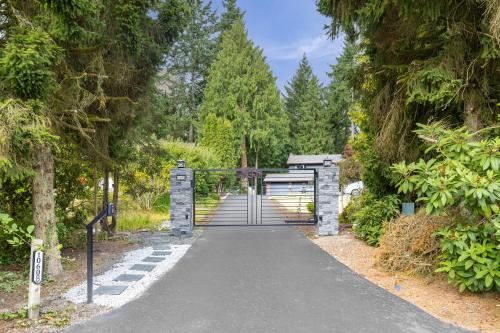 a walkway in a park with trees at Garden Suite Two Bedroom with Hot Tub Sauna Outdoor kitchen and Game Room in Everett