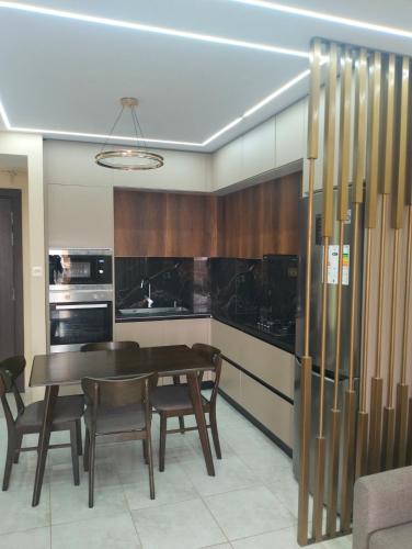 a kitchen with a dining room table and chairs at My Loft in Bejaia in Bejaïa