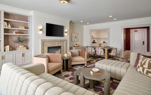 a living room with two couches and a fireplace at Royal Park Hotel in Rochester