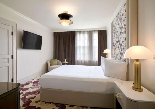 a hotel room with a large white bed and a window at Royal Park Hotel in Rochester