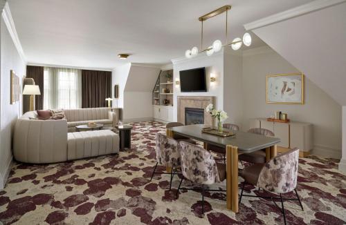 a living room with a couch and a table at Royal Park Hotel in Rochester