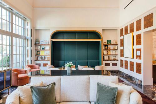 a living room with a couch and a table at Royal Park Hotel in Rochester
