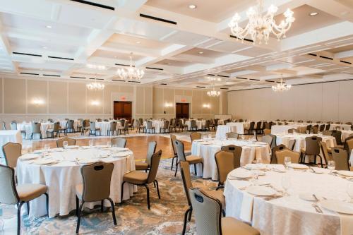 a banquet hall with tables and chairs and chandeliers at Royal Park Hotel in Rochester