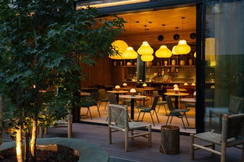 a restaurant with tables and chairs and lights at Zenit Borrell in Barcelona