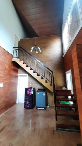 a room with a staircase in a house at Cottage on Riverside in Irinjālakuda