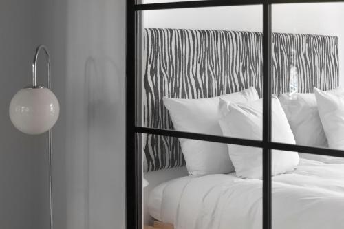 a bed with white pillows in a room at No186 apartments by Daniel&Jacob's in Copenhagen