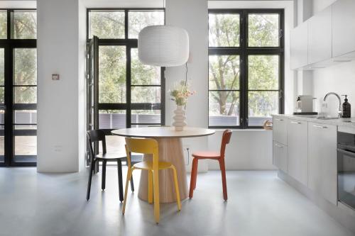 a kitchen with a table with chairs and a vase on it at No186 apartments by Daniel&Jacob's in Copenhagen