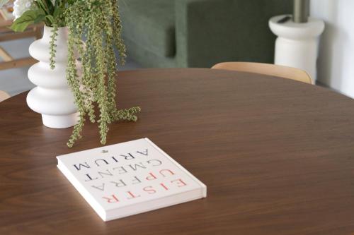 a table with a sign that says unhappy unhappy unhappy killed at No186 apartments by Daniel&Jacob's in Copenhagen