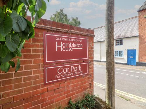 a sign for a car park on a brick wall at Hambleton House in Derby