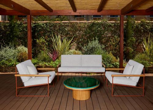 a patio with two chairs and a couch and a table at U-Visionary Venezia Hotel in Venice