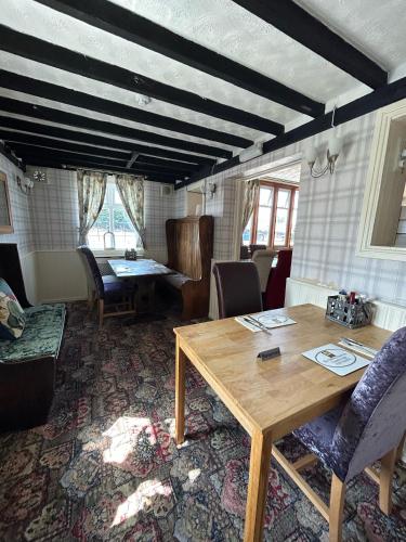 a dining room with a wooden table and chairs at Halfway House Inn Country Lodge in Yeovil