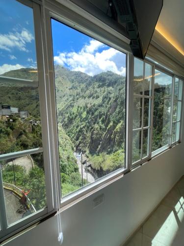 a window with a view of a mountain at Hostal Balcon del Cielo in Baños