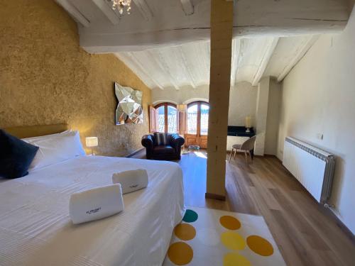 a bedroom with a bed with two laptops on it at El Palauet del Priorat in Cornudella