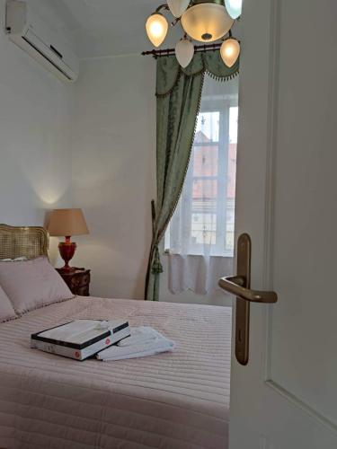 a bedroom with a bed with a book on it at Villa Royal in Cetinje