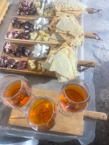 a table with two glasses of tea and a tray of food at Dimora S'Ena Manna in Oliena