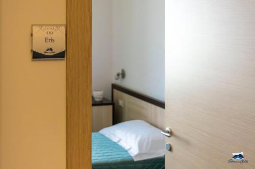 a room with a bed and a door with a mirror at PARCO DELLE STELLE in Castelmauro