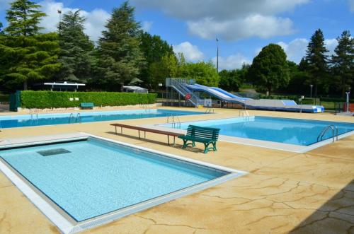 a large swimming pool with a slide in a park at Maison Emeraude - Escapade bistrot chic & nature - Proche Vannes in Sérent