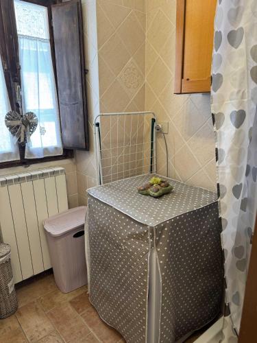 a small table in a bathroom with a sink at Il Castelletto Casa Vacanza in Poggio San Lorenzo