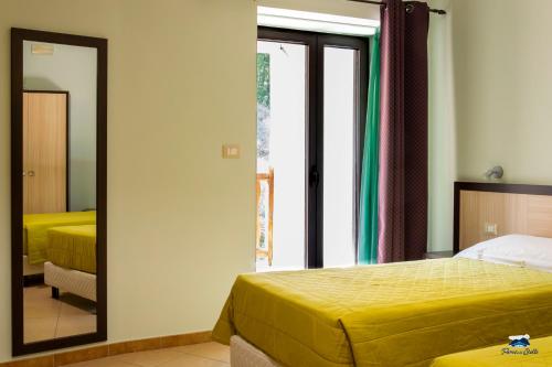 a bedroom with two beds and a mirror at PARCO DELLE STELLE in Castelmauro