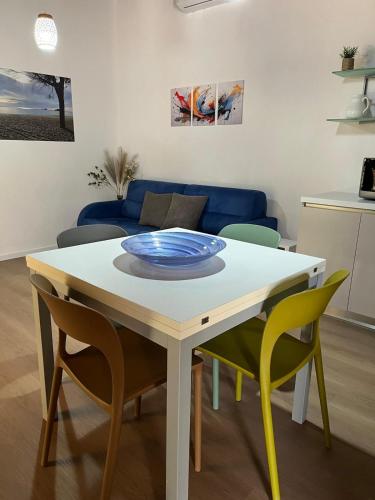 a dining room table with chairs and a blue plate on it at Villa Mia in Seneghe