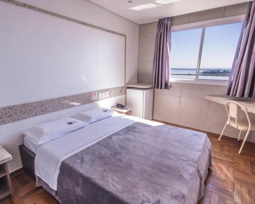 Postel nebo postele na pokoji v ubytování Center Verdes Pássaros Loft