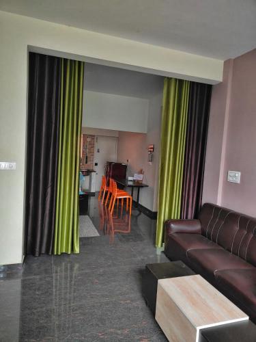 a living room with a couch and a table at Samuels Comfort Homes in Bengaluru